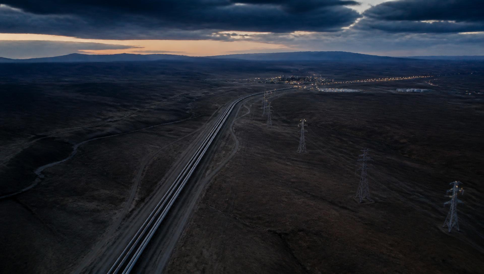Aerial view at twilight of an energy and transmission corridor crossing open terrain